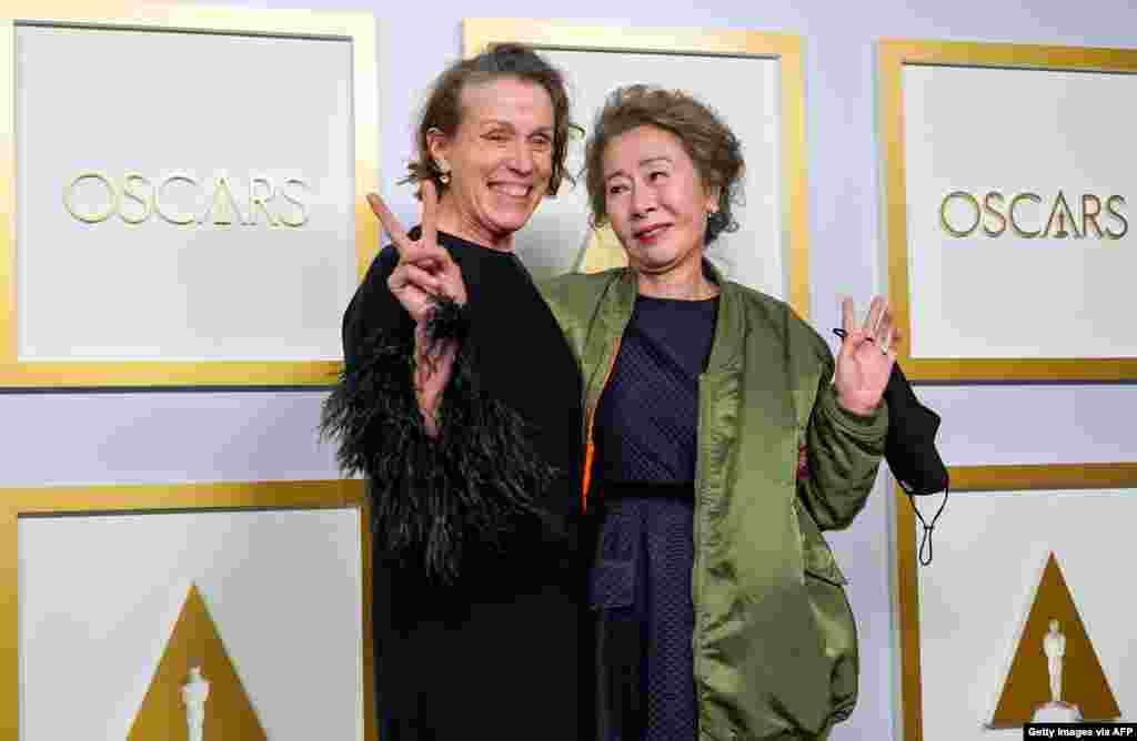 Frances McDormand, left, winner of Best Actress in a Leading Role for 'Nomadland,' and Yuh-Jung Youn, winner of Best Actress in a Supporting Role for 'Minari,' pose in the press room at the Oscars on April 25, 2021.