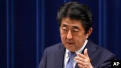 Japan's Prime Minister Shinzo Abe answers a question from a journalist during a press conference at the prime minister's official residence in Tokyo, July 20, 2018. 