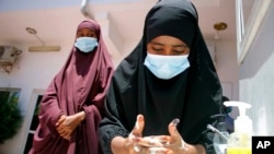 FILE - Somali females wash their hands during coronavirus awareness training conducted by local paramedics and doctors in Mogadishu, March 19, 2020. Classes in the country were shut in March to try to halt the spread of the coronavirus.