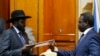 FILE - South Sudan's President Salva Kiir (L) and the country's rebel leader, Riek Machar, exchange signed peace agreement documents in Addis Ababa May 9, 2014.