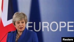 FILE - British Prime Minister Theresa May holds a news conference following an extraordinary European Union leaders summit to discuss Brexit, in Brussels, Belgium April 11, 2019. 