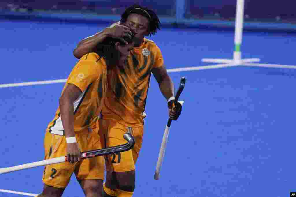 South Africa forward Nqobile Mansuet Ntuli (27) celebrates after South Africa forward Mustaphaa Cassiem (2) scored against the Netherlands during a men's field hockey match at the 2020 Summer Olympics, Sunday, July 25, 2021, in Tokyo, Japan. (AP Photo/John Locher)