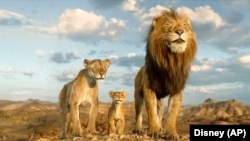 This image released by Disney shows characters Afia, left, Mufasa, center, and Masego, in a scene from "Mufasa: The Lion King." 
