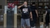 A Chinese man looks out near a Huawei store promoting 5G services in Beijing on Wednesday, July 22, 2020. The United States and Britain have put on a show of unity against the Chinese telecoms giant Huawei, as Secretary of State Mike Pompeo…