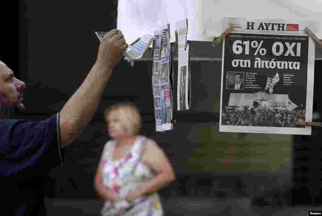 A man looks at newspapers showing the results of yesterday's referendum in central Athens, Greece, July 6, 2015.