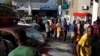 Motorbike riders and car drivers wait to get fuel at a gas station in Port-au-Prince, Haiti, April 7, 2019. 