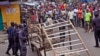 FILE - Liberia security forces blockade an area around the West Point Ebola center as the government clamps down on the movement of people to prevent the spread of the Ebola virus in Monrovia, Liberia, Aug. 20, 2014. 
