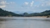 A yellow flag marks the site on the Mekong River in northern Laos where the government plans to build the Luang Prabang hydropower dam. (Zsombor Peter/VOA)