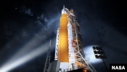 This illustration shows NASA’s new rocket, the Space Launch System (SLS), in its Block 1 crew vehicle setup that will send astronauts to the Moon on the Artemis missions. For the rocket’s first flight on the Artemis I mission, it will send an uncrewed Ori