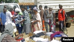 FILE - Families queue at a United Nations Human Rights Council (UNHRC) centre for Burundi refugees in Uvira to receive food ration and clothing in South Kivu in the Democratic Republic of Congo (DRC) May 20, 2015.