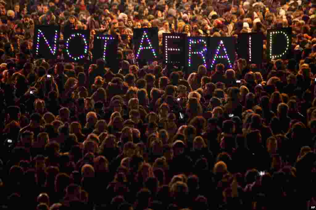 People gather in solidarity of the victims of a terror attack against French satirical weekly Charlie Hebdo, in Paris, France. Masked gunmen shouting "Allahu akbar!" stormed the Paris offices of Charlie Hebdo, killing 12 people, including the paper's editor.