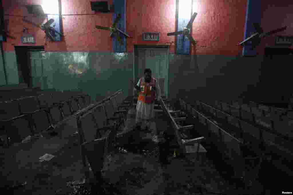 A man collects evidence at a cinema after an explosion in Peshawar, Pakistan, Feb. 2, 2014.