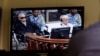 Khieu Samphan, second from right, former Khmer Rouge head of state, and Noun Chea, left, who was the Khmer Rouge's chief ideologist and No. 2 leader, is seen on a screen at the court's press center of the U.N.-backed war crimes tribunal in Phnom Penh, Cam
