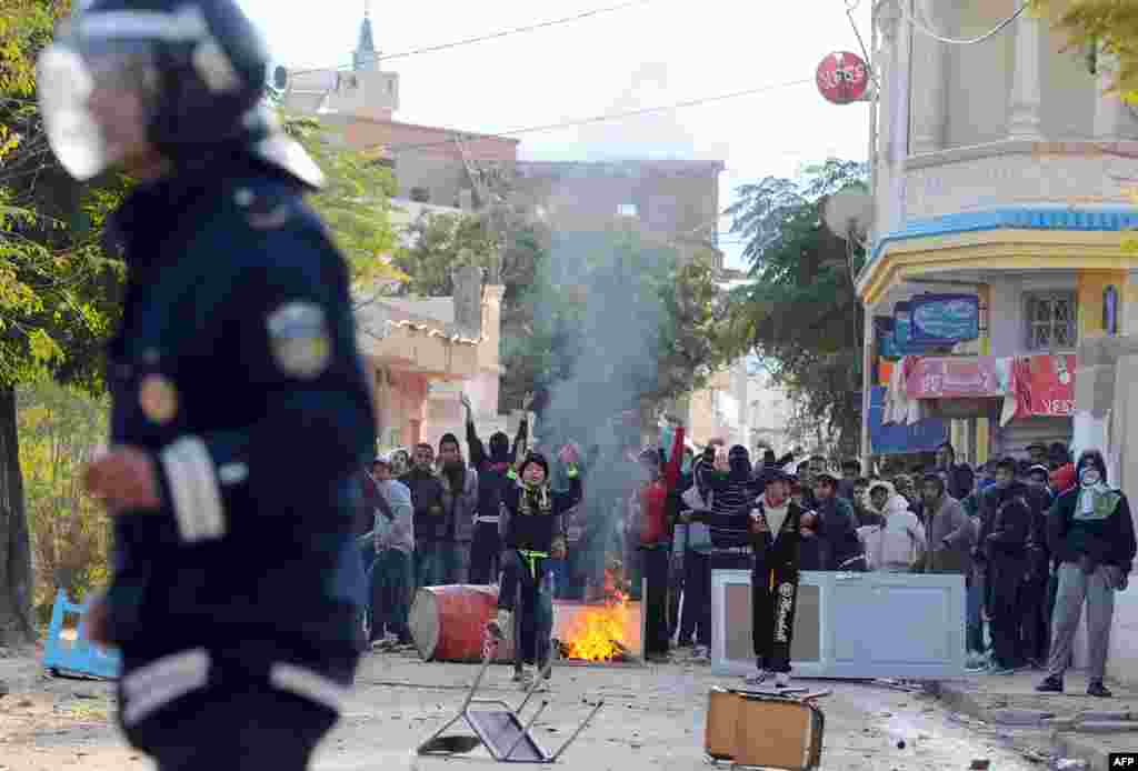 Tunisian protesters clash with police following a demonstration against the country's ruling Islamist Ennahda party in Siliana, northwest of Tunis. A general strike was called to protest against poverty and lack of development.