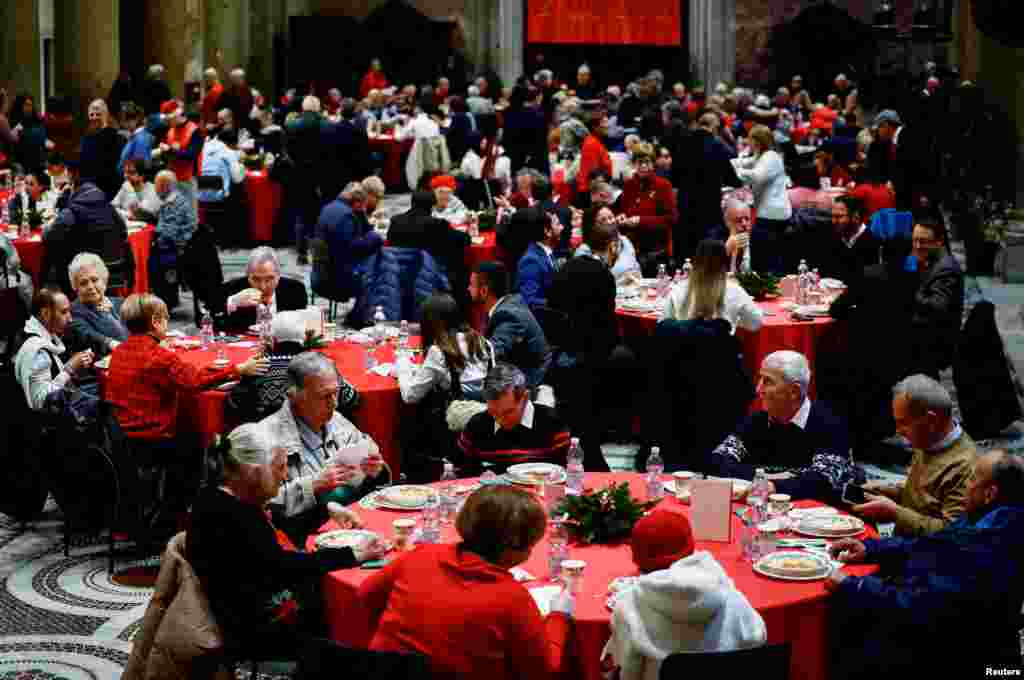 People attend the traditional Christmas lunch for the needy and poor organized by Christian charity Community of Sant'Egidio in the Basilica of Santa Maria in Trastevere, in Rome, Italy, Dec. 25, 2024.