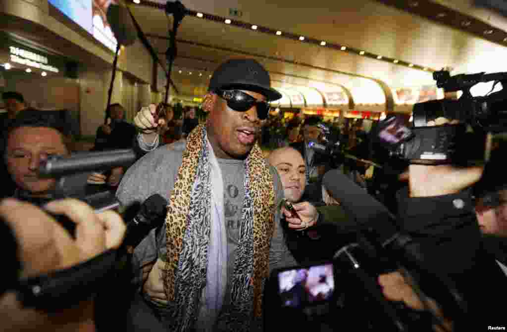 Dennis Rodman speaks to the media after returning from his trip to North Korea at Beijing airport, China, Dec. 23, 2013. 
