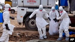Health workers recover the body of a suspected Ebola victim in Monrovia, Liberia.