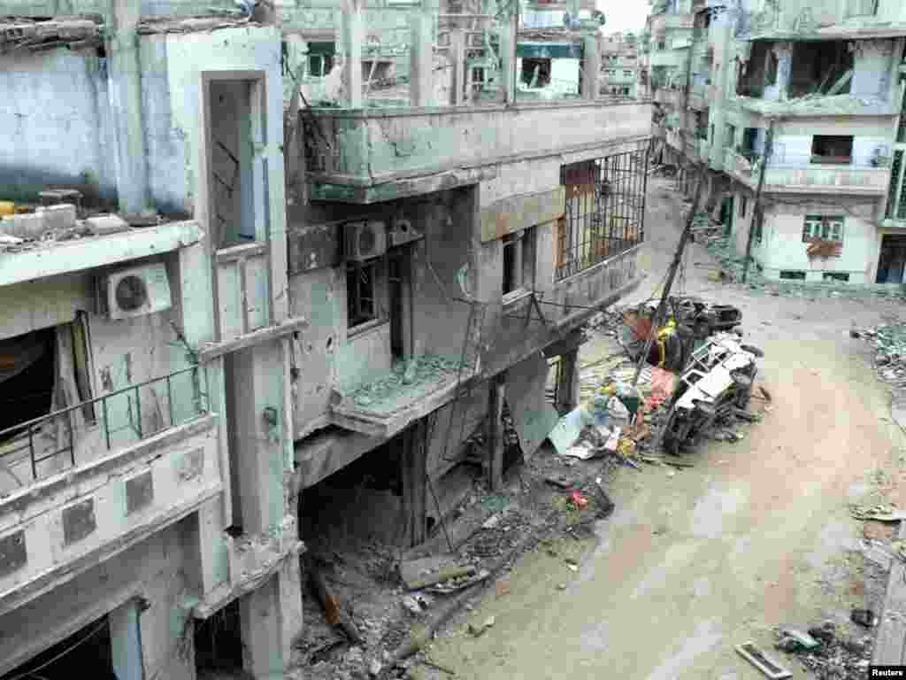 Damaged buildings along a street in the al-Khalidiya neighborhood of Homs, December 5, 2012.