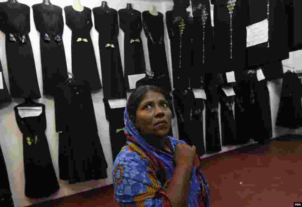 A woman looks at traditional dresses at a shop during Eid al-Fitr in Colombo, Sri Lanka, August 8, 2013. 