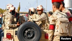 FILE - Military forces look on in North Sinai, Egypt, Dec. 1, 2017.