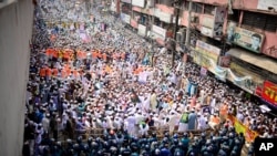 Supporters of Islami Andolan Bangladesh, an Islamist political party, face policemen during a protest against French President Emmanuel Macron and against the publishing of caricatures of the Prophet Muhammad they deem blasphemous, Dhaka, Oct. 27, 2020.