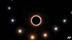This artist's impression provided by the European Southern Observatory in July 2018 shows the path of the star S2 as it passes close to the supermassive black hole at the center of the Milky Way galaxy.
