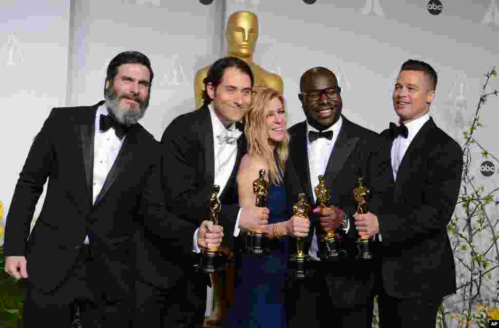 Anthony Katagas, from left, Jeremy Kleiner, Dede Gardner, Steve McQueen, and Brad Pitt pose in the press room with the award for best picture of the year for "12 Years a Slave" during the Oscars.