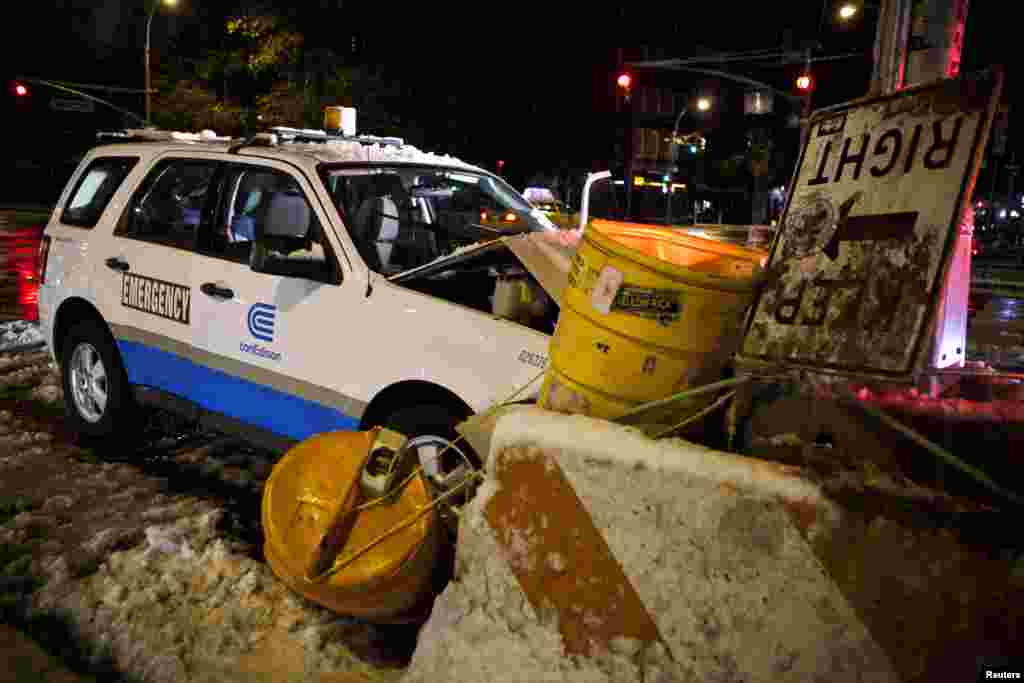 A Con Edison emergency vehicle crashes into a barricade after a nor'easter storm in New York, November 8, 2012.