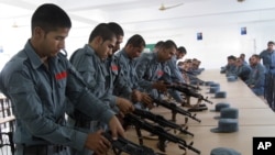 FILE - Afghan security forces practice handling their weapons in Lashkargah, capital of the southern Helmand province, July 23, 2016. More than 900 reportedly were killed that month alone in heavy fighting against Taliban insurgents. 