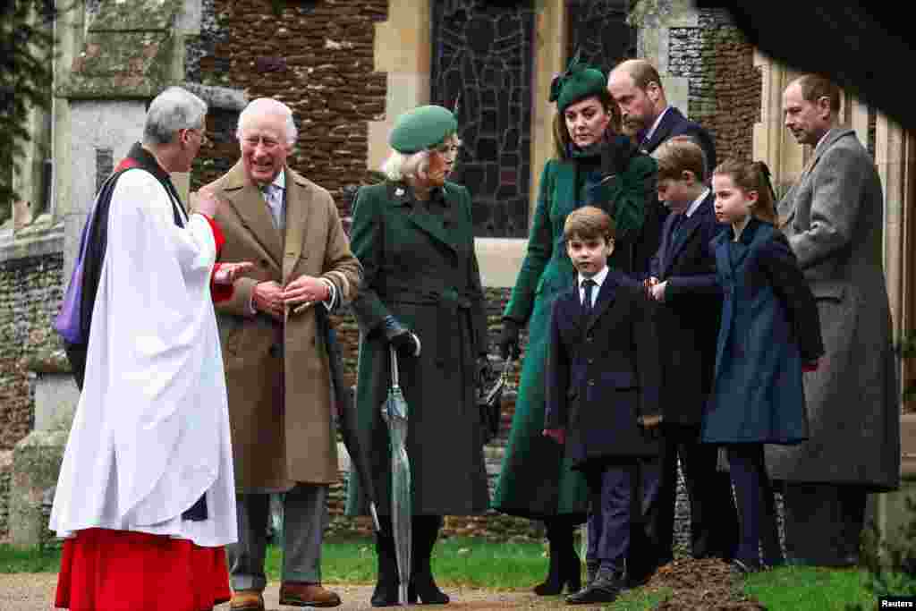 Britain's King Charles speaks with Reverend Canon Dr. Paul Williams, as Queen Camilla, Britain's William, Prince of Wales, Catherine, Princess of Wales, and other family members leave St. Mary Magdalene's church, on the Sandringham estate, Dec. 25, 2024.