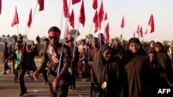Des chiites défilent lors du 40e anniversaire de la cérémonie religieuse de l'Achoura dans le village de Dakasoye, dans le nord du Nigeria, à la suite d'un attentat suicide qui a tué au moins 21 personnes près de Kano, le 27 novembre 2015.
