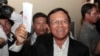 Opposition Cambodia National Rescue Party President Kem Sokha shows off his ballot before voting in local elections in Chak Angre Leu on the outskirts of Phnom Penh, Cambodia, Sunday, June 4, 2017. Cambodians are voting in local elections that could shake