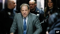 FILE - Harvey Weinstein leaves a Manhattan courthouse during his rape trial, Feb. 18, 2020, in New York.