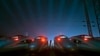 FILE - A worker stands among CRH (China Railway High-speed) Harmony bullet trains at a high-speed train maintenance base in Wuhan, Hubei province, March 9, 2015. 
