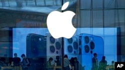 Warga melihat perangkat seluler iPhone 13 terbaru di Apple Store di Beijing, China, 28 September 2021. (Foto: AP)