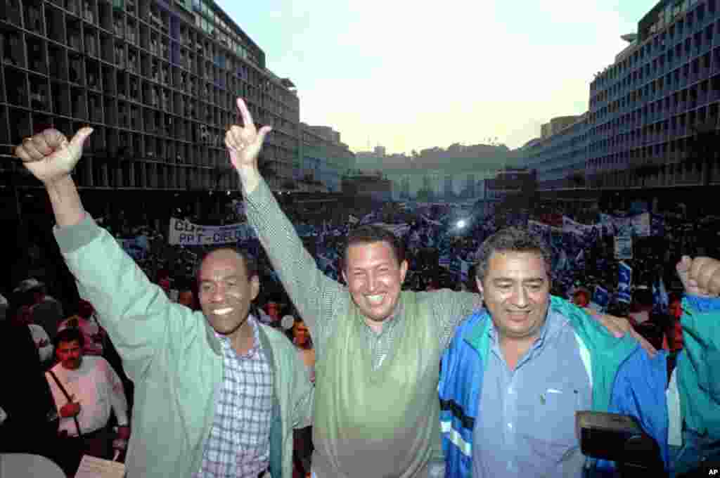 Hugo Chavez, center, Aristobulo Izturi, left, and Pablo Medina appear at a Caracas rally Friday, April 24, 1998.