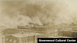 Black Wall Street burns in Tulsa, Oklahoma, June 1921. (Courtesy Greenwood Cultural Center)