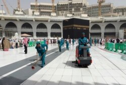 Workers clean the Grand Mosque, during the minor pilgrimage, known as Umrah, in the Muslim holy city of Mecca, Saudi Arabia, March 2, 2020.
