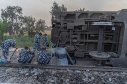 Soldiers are seen at the scene of a train accident north of Cairo in Egypt's Qalyubia province, April 18, 2021. (Hamada Elrasam/VOA)