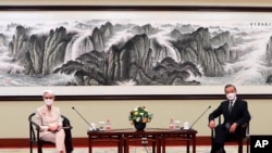 In this photo provided by the U.S. Department of State, U.S. Deputy Secretary of State Wendy Sherman, left, and Chinese Foreign Minister Wang Yi sit together in Tianjin, China, July 26, 2021. 