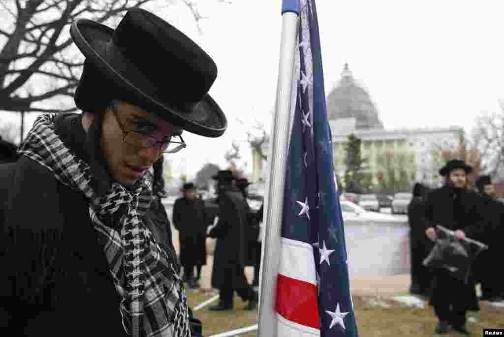 An anti-Zionist Orthodox rabbi is pictured next to a U.S. flag during a protest against Israeli Prime Minister Benjamin Netanyahu's speech to a joint meeting of Congress on Capitol Hill in Washington, March 3, 2015.