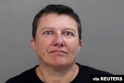FILE - Pascale Ferrier appears in a jail booking photograph taken after her arrest by the Mission Police Department in Mission, Texas, March 13, 2019.