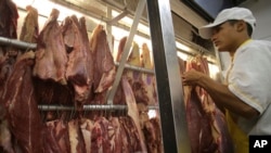 An employee works in a butcher shop in Brasilia, Brazil, Monday, March 20, 2017. 
