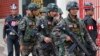 FILE - Soldiers patrol around the Royal Thai Army Headquarters as members of the Radio and Satellite Broadcasters gather in Bangkok, June 18, 2014. 