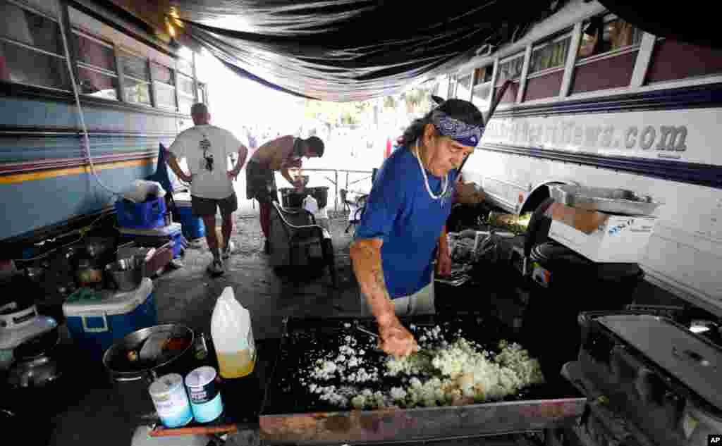 Men prepare food in a protest camp called &quot;Romneyville&quot; outside the convention center.