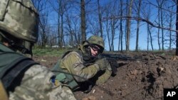 FILE - Ukrainian soldiers hold their position during a cease-fire, outside Avdiivka, Donetsk region, eastern Ukraine, April 16, 2016. 