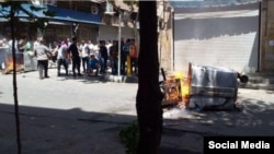 Para pengunjuk rasa anti-pemerintah yang marah dengan kondisi Iran yang makin memburuk membakar tempat-tempat sampah di distrik Laleh Zar, di Tehran, 26 Juni 2018.