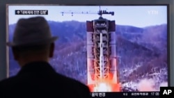 FILE - A man watches a TV news program showing a file footage of North Korea's rocket launch at Seoul Railway Station in Seoul, South Korea, April 28, 2016.