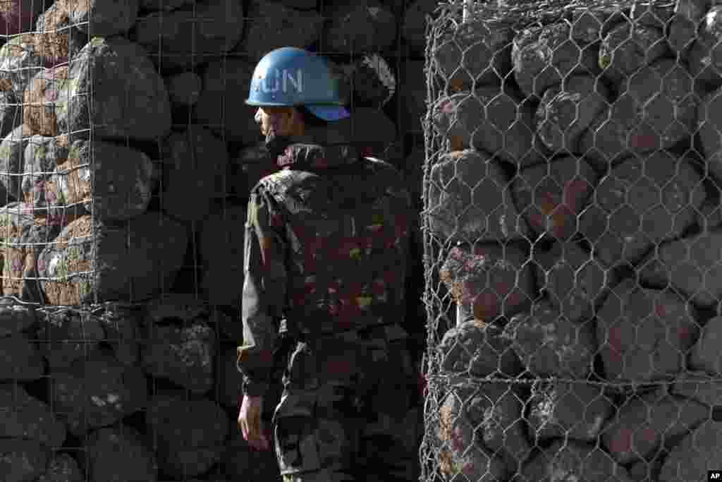 A U.N. soldier stands next to a shelter inside a UN base near the Quneitra crossing between Israel and Syria, June 7, 2013.