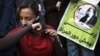 An Egyptian woman cuts her hair during a demonstration in Tahrir Square, Cairo, Egypt, Dec. 25, 2012. 